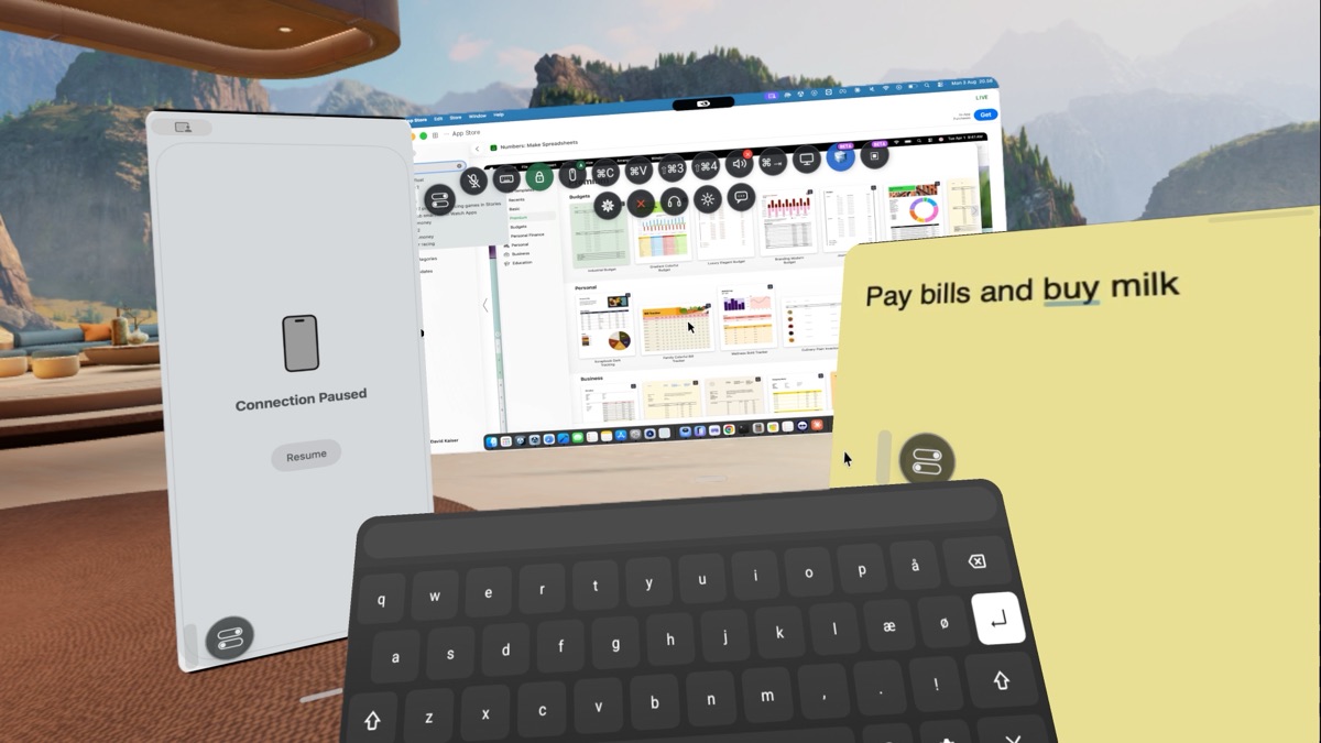 Working at a mountain lake: Mac screen, iPhone panel, a note and the built-in keyboard
